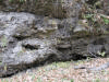The side of a cliff, showing evidence of erosion from long ago